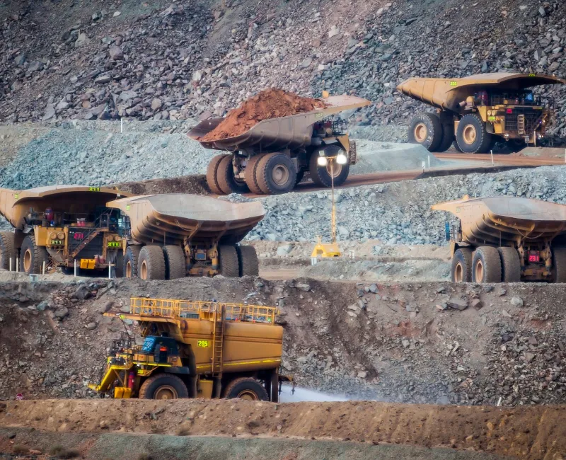 Multiple mining trucks in a mining site