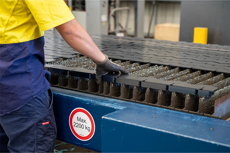 Man handling laser cut steel plate